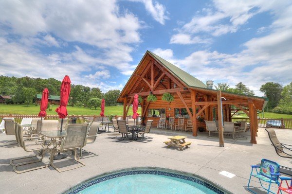 Outdoor pool and clubhouse for guest use at Friends in High Places, a 4-bedroom cabin rental located in Pigeon Forge